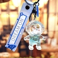 Portachiavi astronauta con cinturino blu e scritta Dream On per borsa e auto - Astronauta dell'Oceano Blu - Viso Giallo Seduto
