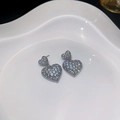 Silver heart earrings with cubic zirconia pavé finish on white ceramic tray - E4315-925 Sterling Silver Earring Post / Silver White Rhinestone
