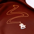 Golden unicorn pendant necklace with colorful enamel detailing on dark red fabric background - Colorful Enamel Unicorn (WN15)