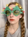 Close-up of a person wearing festive green Christmas tree party glasses with pom-poms - Large Christmas Tree