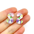 Close-up of white acrylic letter S pendant with colorful cartoon patterns for DIY jewelry - Letter S