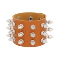 Detail of punk style brown leather bracelet with multiple rows of silver cone spike studs - Tan