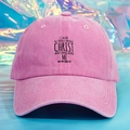 Detailed close-up of pink washed cotton baseball cap with black scripture printing - Pink