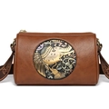 Brown leather cylinder shoulder bag with wide strap and metallic elephant emblem - Brown