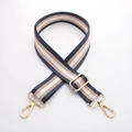 Close-up of adjustable striped canvas bag strap with golden metal swivel hooks - 3.8cm Wide Gold Silk