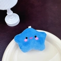 Blue plush star keychain with embroidered smiley face on a white porcelain dish - Dark Blue Star (No Clasp)
