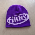 Detail of purple knitted beanie featuring jacquard filthy text and ribbed texture - One Size (54-59cm) / Purple