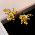 Macro detail of golden petal earrings showing irregular pleated texture and metallic luster - Silver Needle - Golden Wrinkled Flower Stud Earrings