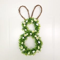 Close-up of Easter rabbit wreath with speckled eggs and white daisies on green foliage - 50*25cm