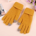Close-up of ginger yellow knit gloves featuring touch-screen tips and ribbed cuffs - Pineapple Texture Yellow