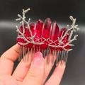Detailed view of dark red crystal pillars on silver branch hair comb held in hand - Dark Red + Branch