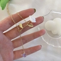 Golden necklace with a white 3D rose pendant and a purple gradient drop bead detail - Rose Water Drop Style