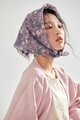 Close-up of a floral cotton linen scarf styled as a headband on a model's head - Dark Grey Floral