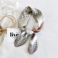 Elegant geometric dot silk scarf with pastel color block design tied in a decorative knot - New Grid Beige Grey Edge