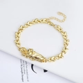 Detailed close-up of golden Saint Jude religious pendant and butterfly links bracelet - Gold Saint Jude Butterfly Link