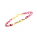 Macro detail of high-quality gold-plated faceted beads with pink carnelian stones on a bracelet - Strawberry Quartz Snowflake Plate