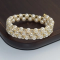 Detailed view of triple-layer gold bracelet with white pearls and sparkling rhinestones - 3 Rows Gold