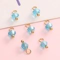 Faceted 4mm blue glass bead charms with gold metal loops for DIY jewelry making - Lake Blue Bicone Bead