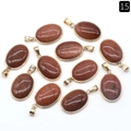 Oval goldstone pendants with golden metal bezel settings and glittery brown finish - Gold Sand Stone (Synthetic)