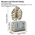 Golden monstera leaf perpetual calendar with metal frame and stone-like date blocks - Iron Art Calendar Ornament - Monstera