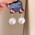 Close-up of 925 silver needle earrings with purple crystal and white pearl detail - Gold-Purple-Stitched Triangle