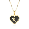 Detailed close-up of gold heart pendant with black enamel inlay and cursive letter K - Letter K Style
