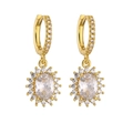Detail shot of gold-plated hoop earrings with sparkling zircon sunflower pendants - Gold Oval