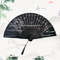 Traditional black folding fan featuring bamboo and dragonfly patterns with silk tassel - Bamboo Charm - Black Handle