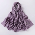 Detailed close-up of lavender chiffon hijab featuring exquisite rhinestone flower patterns - Purple