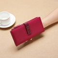 Chic red long leather wallet with secure zipper and strap held by a model - Red