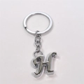 Polished silver metal letter H keychain with circular ring and chain on white background - Letter H / Silver