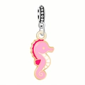 Detailed view of seahorse alloy pendant with pink enamel and golden metal borders - Pink Seahorse