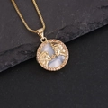 Macro shot of 18K gold Pisces zodiac pendant with shell center and pink crystals on rock - 3#Gemini