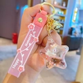 Pink liquid sand star keychain with white cartoon unicorn and Happy Moments strap - Pink-Star Unicorn