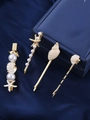Juego de clips dorados con estrellas de mar y perlas sobre fondo de terciopelo azul - Blanco