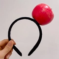 Funny black velvet headband featuring a realistic large red apple vegetable accessory - Apple