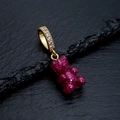 Pink resin gummy bear pendant with glitter and gold-plated bail on stone background - Glitter Star Purple