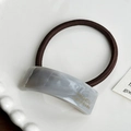Minimalist marble pattern resin hair tie with gold lettering on a white ceramic plate - 4.4cm / Gray