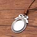 Antique silver oval pendant tray with bow detail on a brown braided PU cord necklace - Bowknot Oval Style(14)