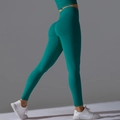 Detail of emerald green high waist yoga leggings with push-up stitching and elastic fabric - Dark Green