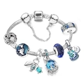 Macro view of ocean charms including octopus and turtle on a silver bracelet - A5 / 17cm