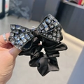 Large black satin scrunchie featuring a premium oversized crystal bow with grey rhinestones - Bow Scrunchie / Gray