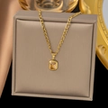 Detailed shot of a gold butterfly zircon pendant on a beige jewelry box backdrop - Champagne Rhinestone Pendant (H631)