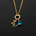 Gold plated stainless steel cursive letter necklace featuring a blue gemstone pendant - Letter W