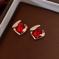 Detailed macro shot of red gemstone earrings with gold-plated geometric metal settings - Silver Earring Post - Red