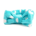 Close-up van blauwe koraalvlies hoofdband met witte stippen en decoratieve strik - Wit met muntgroene stippen