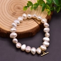 Handmade baroque freshwater pearl bracelet with gold toggle clasp on a rustic wood stand - Baroque Pearl Elastic Bracelet