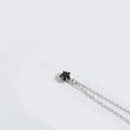 Minimalist silver chain necklace featuring a small black five-pointed star pendant charm - Black (Silver Chain)