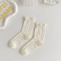 Detail of white mesh knit crew socks featuring lace ruffled cuffs and bowknot JK style - Argyle Hollow Ruffle Style