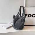 Black washed denim bucket bag featuring delicate floral embroidery and wide strap - Black